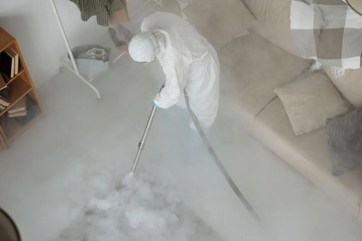 Biohazard cleanup technician in protective equipment, Kechi, KS